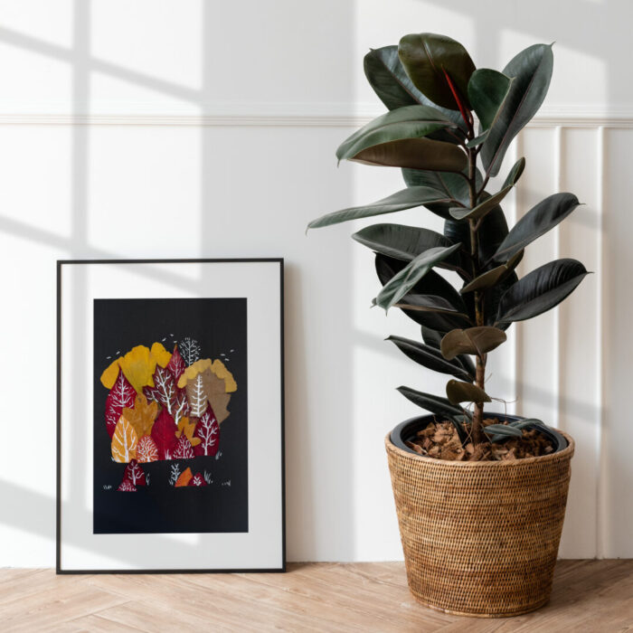 Colourful fall leaves in a picture frame as art White marker drawn over colourful fall leaves that are in a picture frame as an artwork