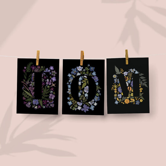 creating a first name on the wall with the pressed flower collection, initial cards with T, O, M