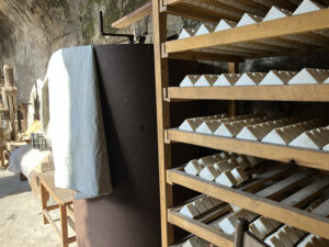 handmade soaps drying on wooden rack in the family workshop