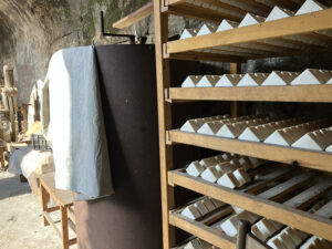 traditional soaps drying on wooden rack-Botanopia handmade soaps drying on wooden rack in the family workshop