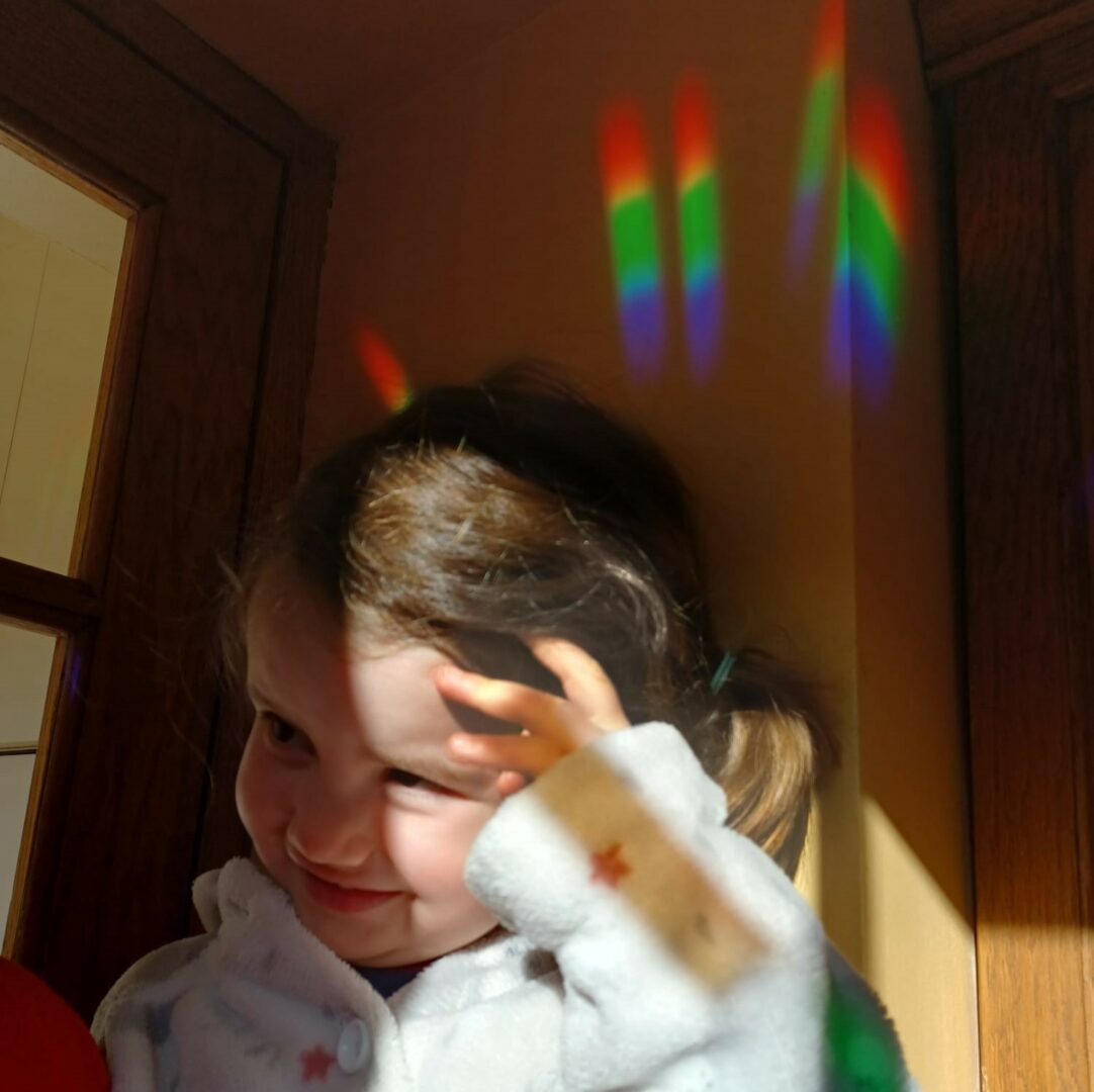 rainbows on the wall, with a child