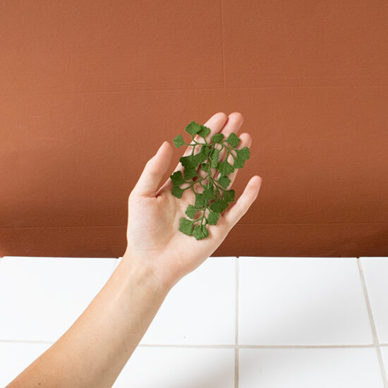 Maidenhair fern embroidered brooch holding in hand