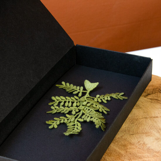 Olive branch embroidered brooch close up packaging