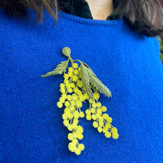 Mimosa flowers embroidered brooch on blue sweater