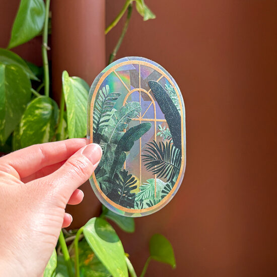 Greenhouse glow Rainbow maker sticker holding in hand