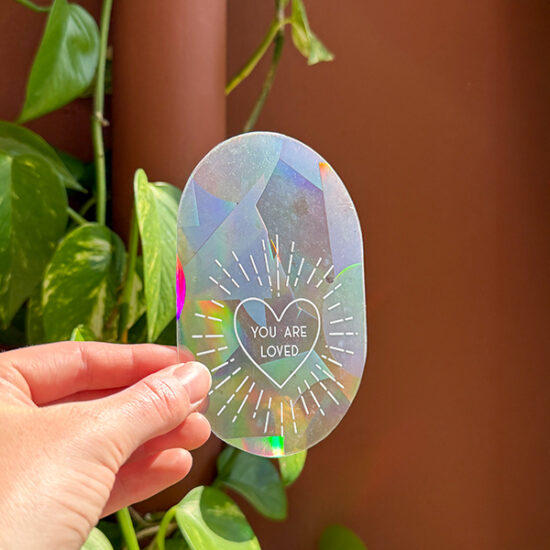 You are loved Rainbow maker sticker holding in hand