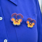 Pansies embroidered brooches on blue blouse